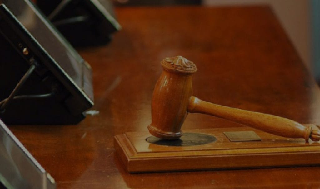 A gavel rests on a desk