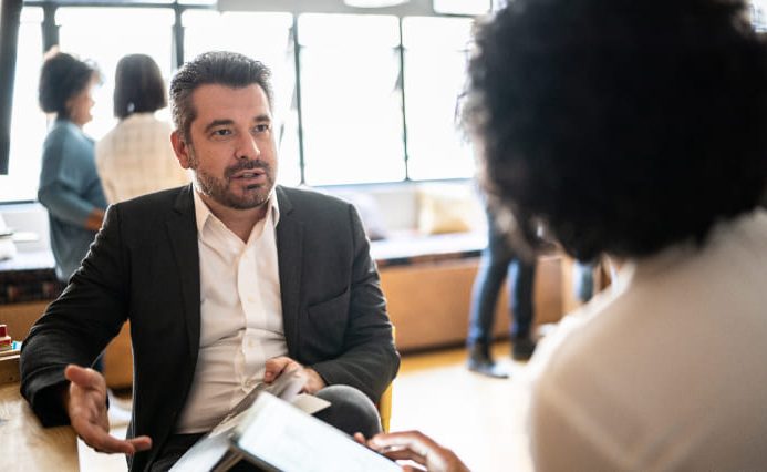 a restaurant branding team lead talking to their client